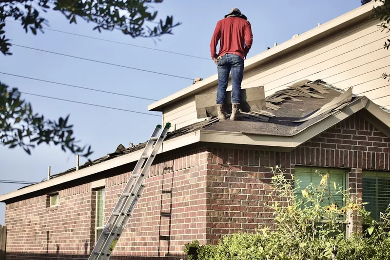 Professional roofer working on a residential roof in Castle Pines